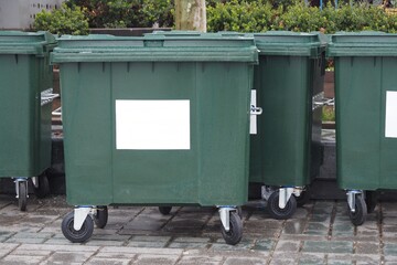  Metal green garbage can with wheels in countryside 
