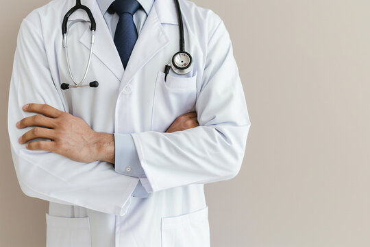 Photo of A doctor in white coat with stethoscope on chest, isolated on light background. Close up portrait of male medical worker standing and looking at camera.otd concept, stock photo for adobe stoc