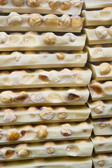 pile of broken white chocolate with hazelnuts 