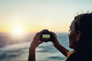 Beach, sunset or woman with camera in nature for photography, memory or scenic capture on summer,...