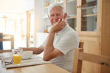 Elderly, man and happy with portrait at breakfast in dining room for nutrition. healthy meal and retirement. Senior, person and smile in home with cereal, relax and morning routine in apartment