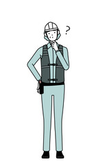 Senior female engineer in helmet and work wear nodding her head in question.