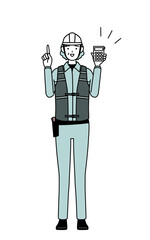 Senior female engineer in helmet and work wear holding a calculator and pointing.