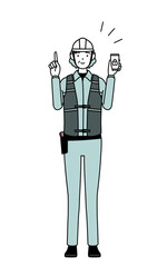 Senior female engineer in helmet and work wear taking security measures for her phone.