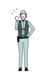 Senior female engineer in helmet and work wear posing with guts.