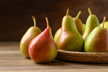 Pear fruit in natural basket on wooden background, Healthy fruit