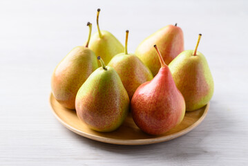 Fresh pear fruit on wooden plate with white table, Healthy fruit