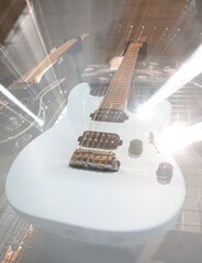White electric guitar with a strange zoom optical effect and lights created by moving camera lens