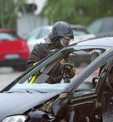 firefighters put out the fire in a crashed car after the collision