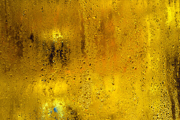 wet glass. yellow abstract background