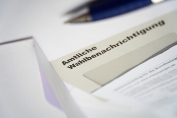 Official election notification (Wahlbenachrichtigung Bundestagswahl) for the federal election in germany. Opened envelope and blue pen depth of field.