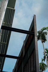 A building with a large window and a palm tree in the background