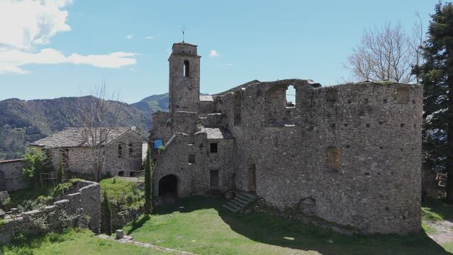 Aerial of the old medieval San Nicolo church in Bajardo Italy