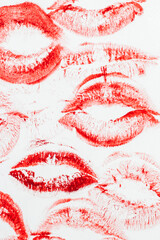 Imprint of red lips on white paper, kiss background