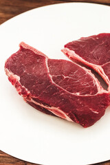 A piece of premium meat, striploin steak on a wooden table