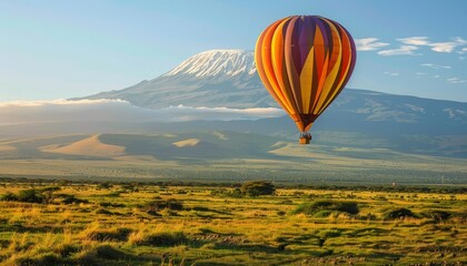 Obraz premium Chasing the Snowy Summit: A Magical Hot Air Balloon Safari in Amboseli National Park