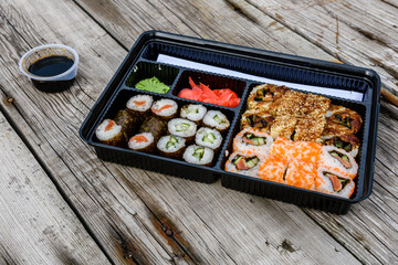 Set of the different sushi on wooden table