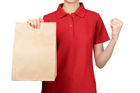 Woman employee in red shirt uniform holding craft paper package isolated on gray background.