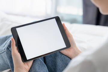 Hand holding digital tablet mockup of blank screen for graphic display montage.