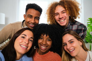 Group of multiethnic happy friends taking a selfie at home. Smiling people portrait.