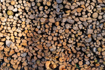 a pile of large piles of chopped wood is next to each other