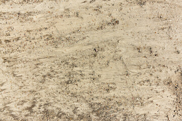 Sand with pebbles texture background close up