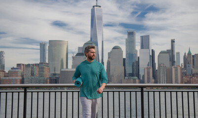 Man Doing Exercises in New York City outdoor. Happy man workout in New York city. Senior runner motivation for fitness, energy and healthy exercise training. Sport, fitness and exercise.
