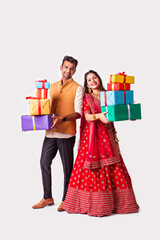 Asian Indian young couple standing against white background hold