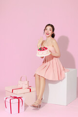 Portrait of cute Asian woman in pink dress gesture feeling surprise happiness with valentine or...