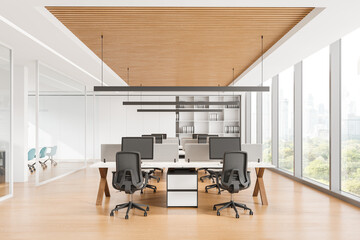Modern office interior with workstations and computers, bright lighting, wood and white finish....