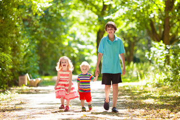 Kids play in summer park. Children run outdoor