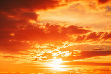 A dramatic sunset sky with vibrant orange clouds