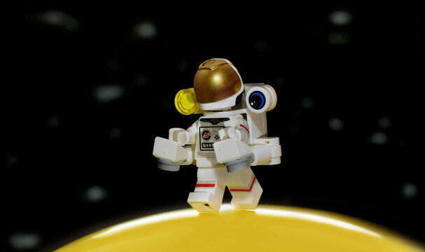Lego minifigure of astronaut in space suits in Galaxy on Moon. Editorial illustrative image to popular children plastic collectable constructor toy.