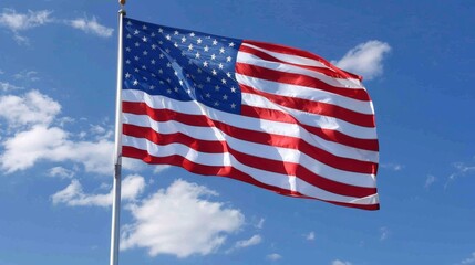 Fototapeta premium Flag of United States of America being waved in the breeze against a sky. USA flag
