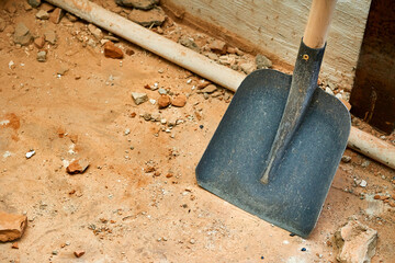 Scoop shovel on garbage collection at construction site, repair