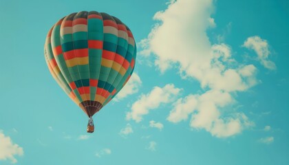 Fototapeta premium Vibrant Hot Air Balloon Soaring through a Clear Blue Sky