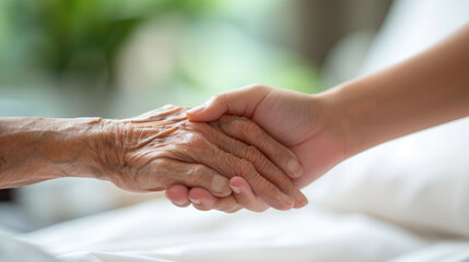 Closeup of loving couple holding hands while sick , Hand of young woman touching old woman in hospital