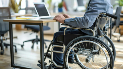 Fototapeta premium a man in a wheelchair sits at a desk in the office