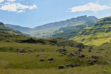 Obraz premium Driving view from Sani Pass (2,876 meters) to the rock formations of the Twelve Apostles in the Drakensberg Mountains and the landscape of KwaZulu-Nathal province. Republic of South Africa. Africa.