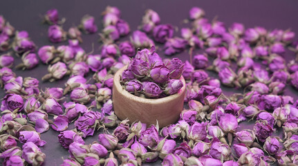 Dried damask rose buds in a small wooden container