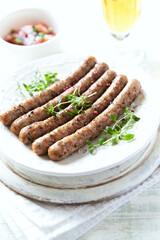 Roasted white sausages on bright wooden background. Copy spaces.
