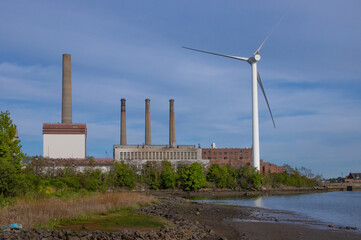 Old fossil fuel power station and wind turbine at the Mystic River, Boston