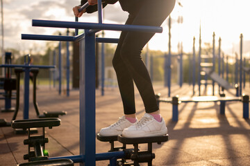 Female person Exercising on Stepper at Outdoor Fitness Park in the Evening, sport workout