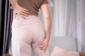 Sciatica concept with woman feeling nerve pain from lower back and goes down to legs