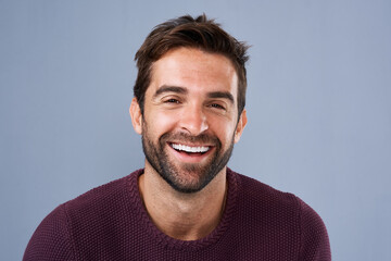 Fototapeta premium Happy, employee and face of man, studio and proud with career in media, creative and cheerful in New York. Blue background, portrait and confidence of journalist, person and staff in business of USA