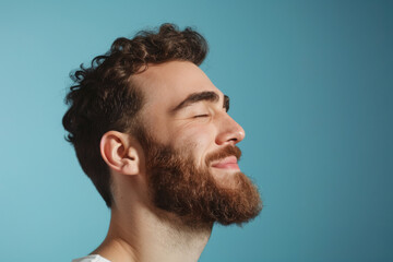 Obraz premium A close up of a man with beard and closed eyes looking to a side