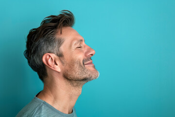 Fototapeta premium A close up of a man with beard and closed eyes looking to a side