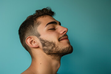 Fototapeta premium A close up of a man with beard and closed eyes looking to a side