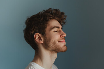 Fototapeta premium A close up of a man with beard and closed eyes looking to a side