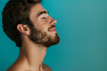 Fototapeta premium A close up of a man with beard and closed eyes looking to a side